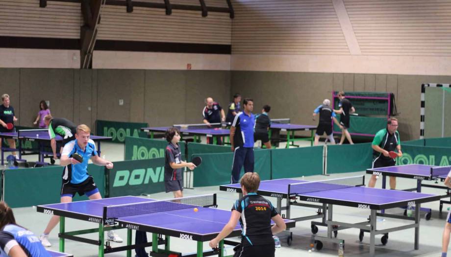 IMG_1734 Modernes Tischtennistraining in einer Indoor-Halle mit mehreren Tischen und Spielern unterschiedlichen Alters, ideal für Tischtennis-Training und -Wettkämpfe im Verein.